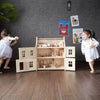 Plan Toys Victorian Doll House with children playing | Conscious Craft